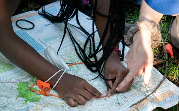 two people point out a location on a map on an expedition with outward bound